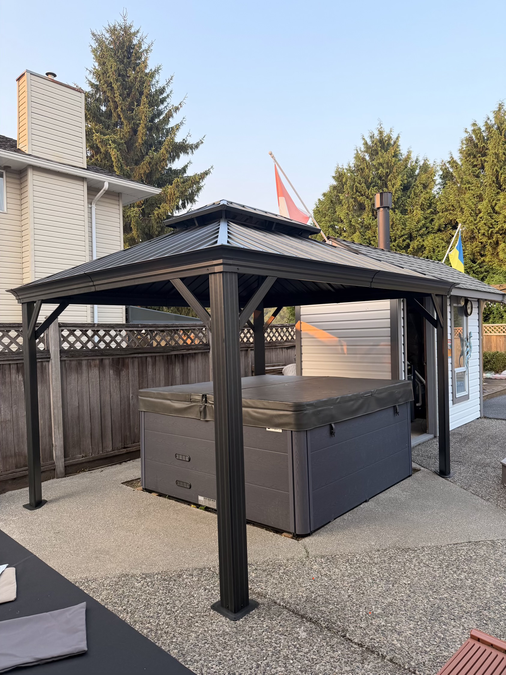 Hard-top gazebo built and installed over a hot tub in a Langley backyard